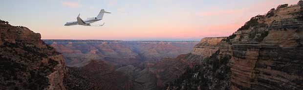 Airplane flying in the Grand Canyon at dusk
